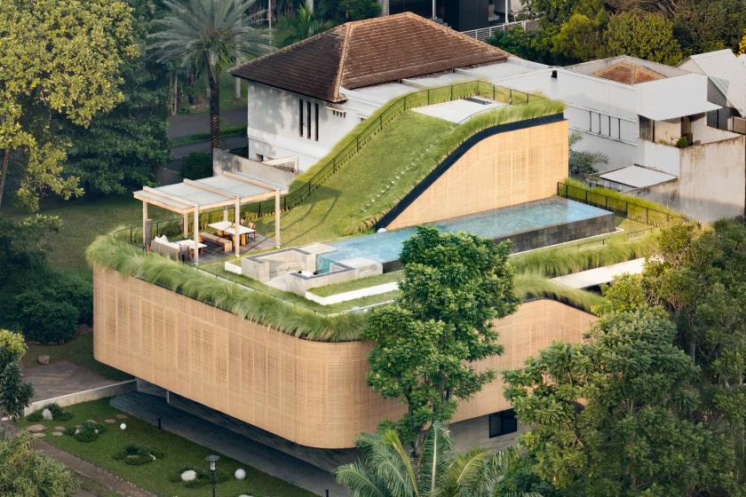 Green Rooftop With Pool Indonesian home features sloping rooftop garden with pool and cinema