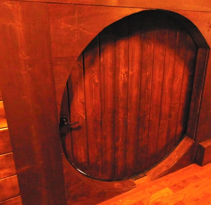 Entry to the tiny house is via a hobbit-style circular door