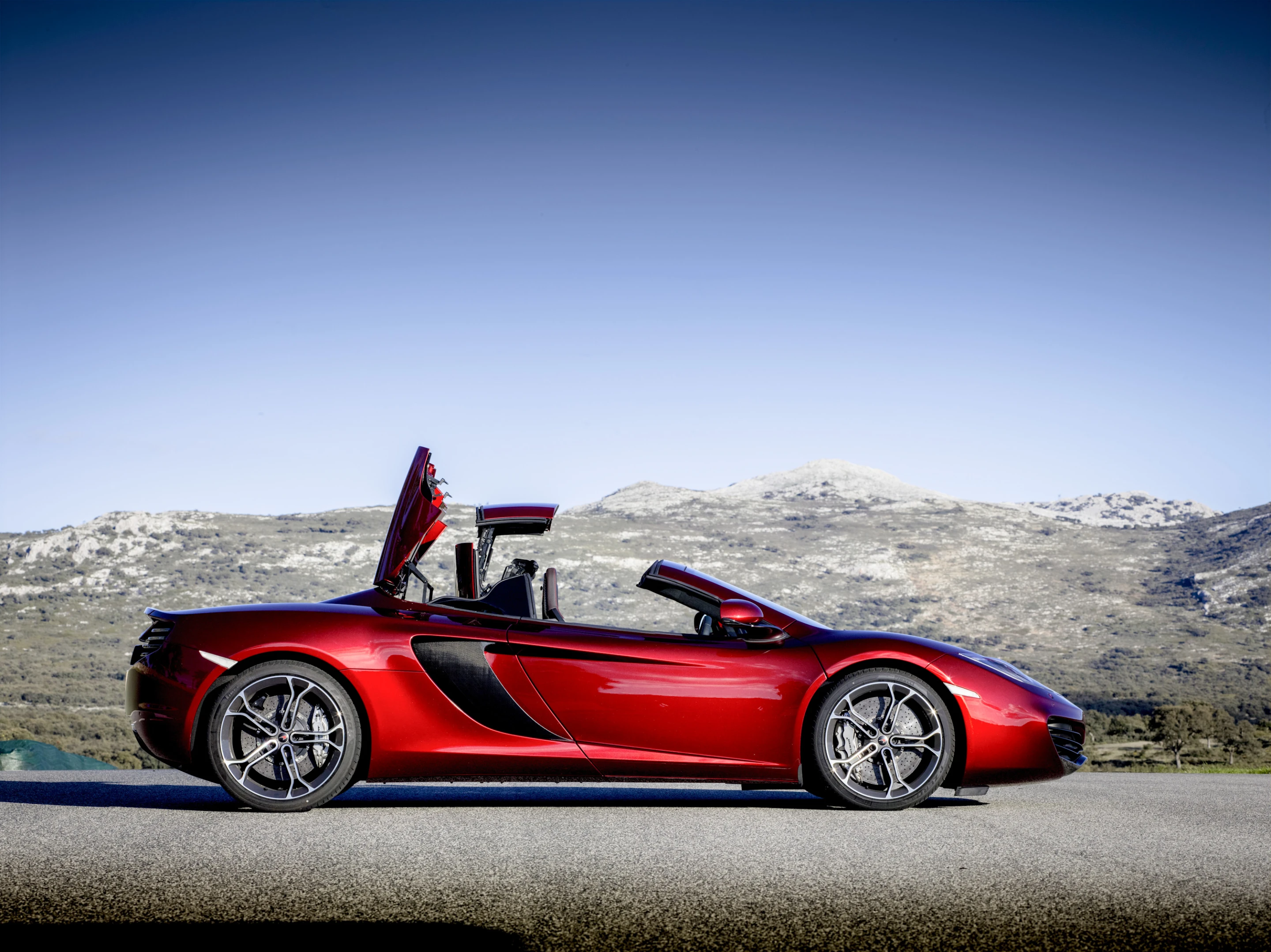 The 12C Spider's two-piece top can be raised and lowered in 17 seconds at speeds up to 19 mph (Photo: McLaren)
