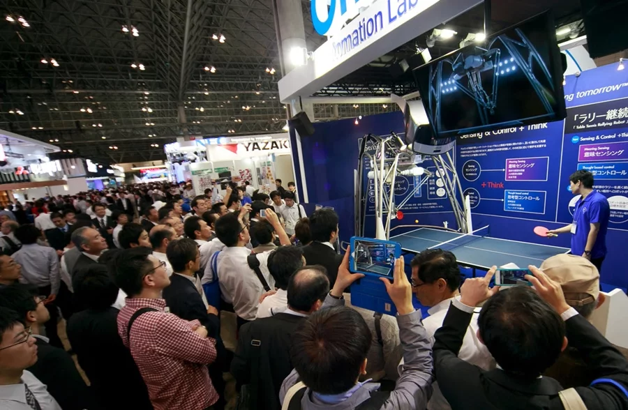 A large crowd watches the robot play at CEATEC