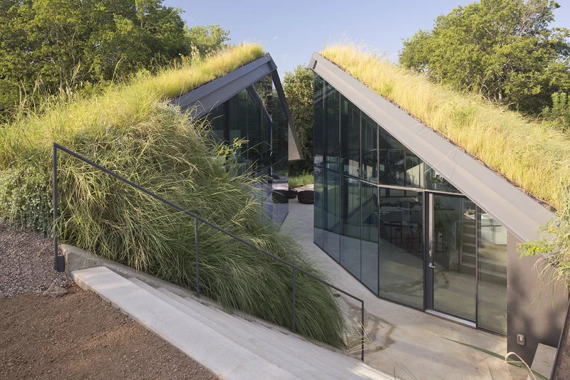 Edgeland House, modeled on the Native American Pit House, is buried 7 ft below ground level and is divided into two clear halves - sleeping and living sectors