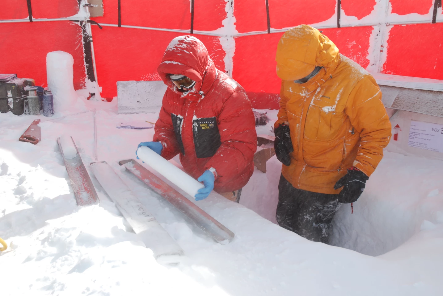 Andrew Smith (L) and Jon Edwards work to study historic methane emissions from ice samples