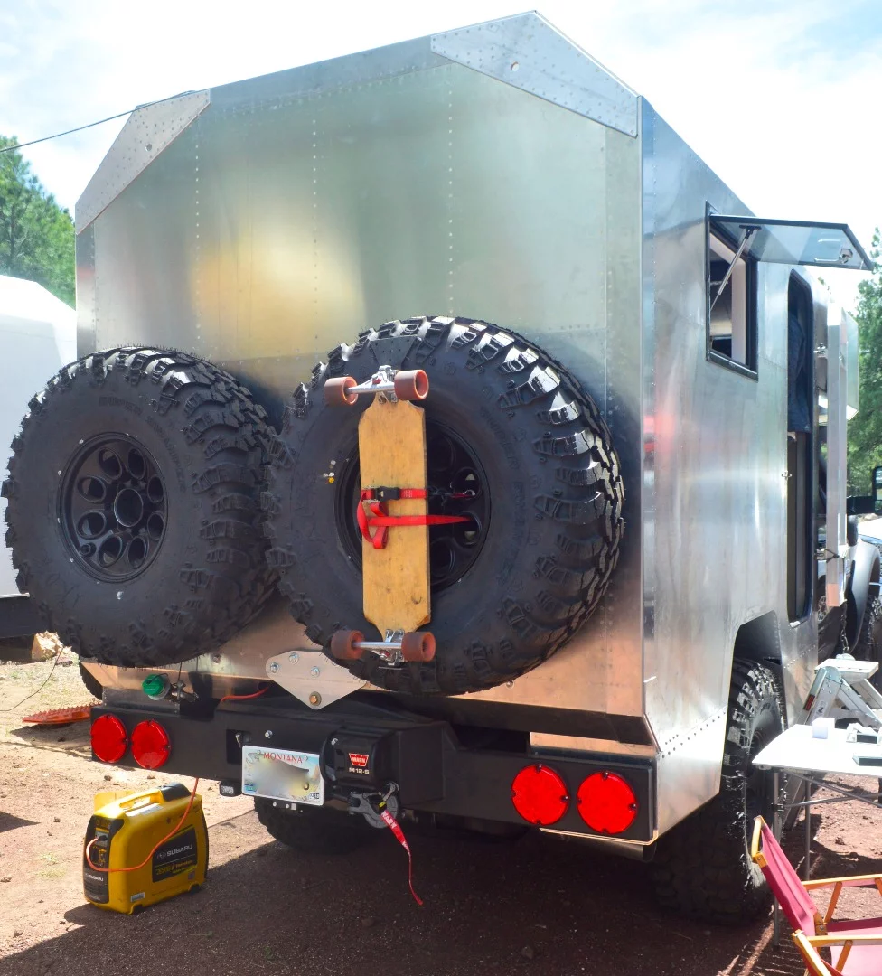 We're used to seeing bikes and motorcycles on the back of big expedition rigs, but this skateboard is a first