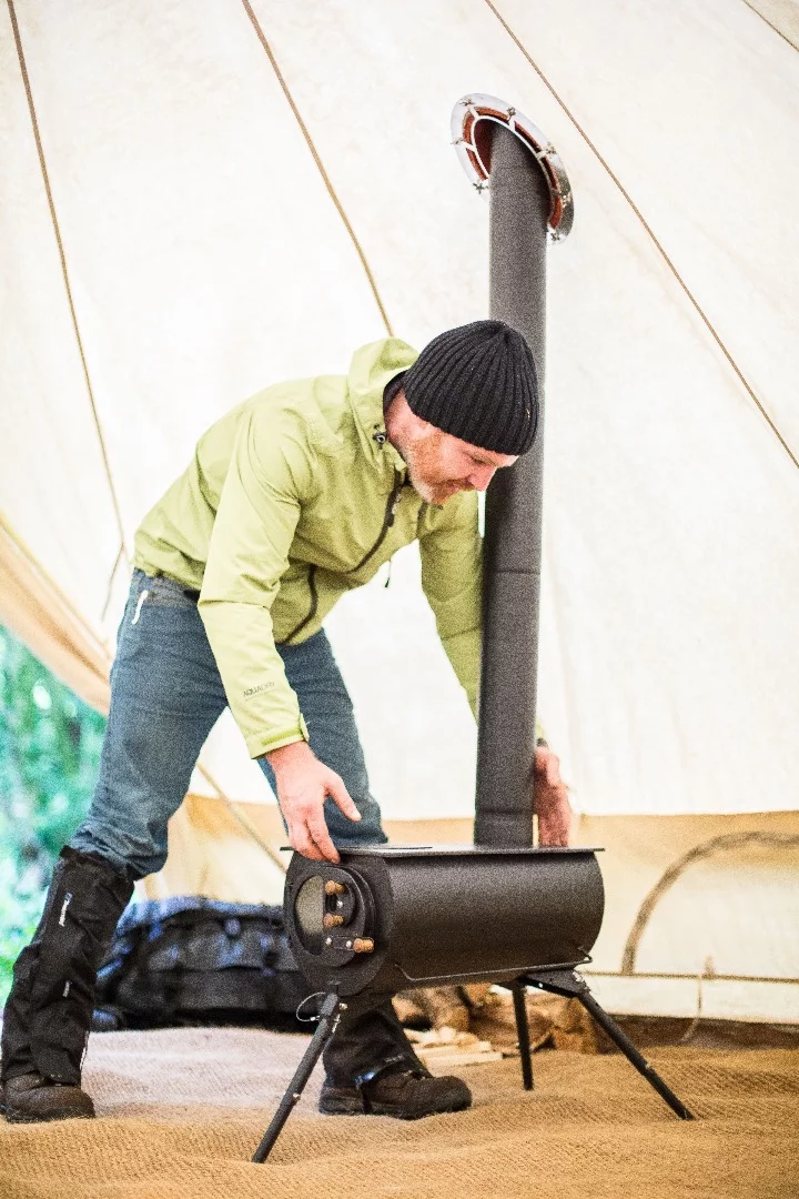 The flue can exit through a side wall, roof, or the vent of a tent