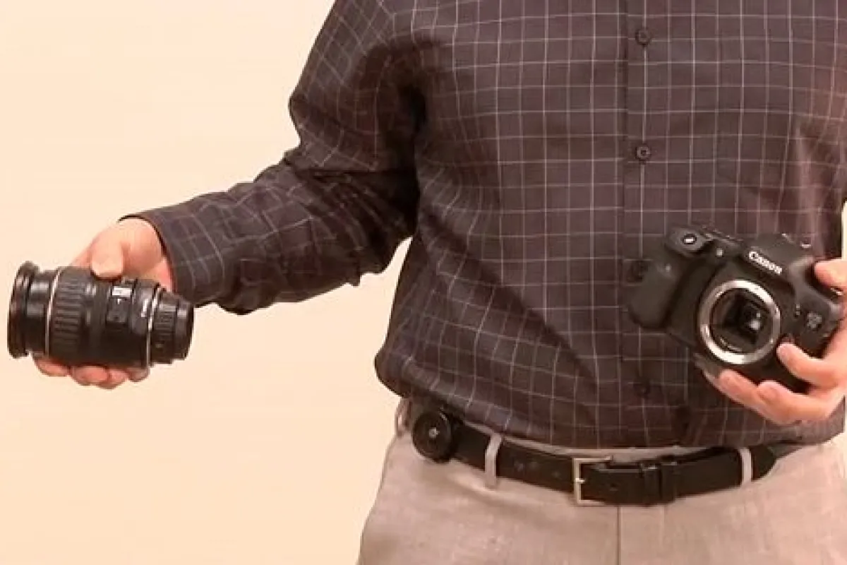 The Backer Capper (seen here mounted on a belt) is a product that's designed to make it easier for photographers to change lenses when they can't put their camera down