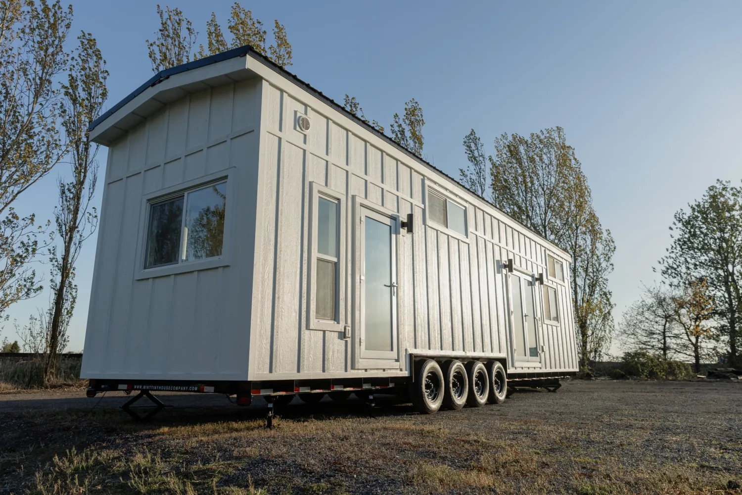 The Ventura Park Model Tiny Home is finished in engineered wood board and batten siding