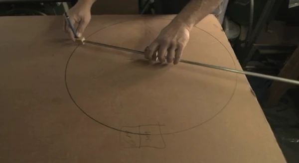 Gafni begins making a cardboard bike by sourcing suitable cardboard and cutting it into the desired shapes to be used as parts