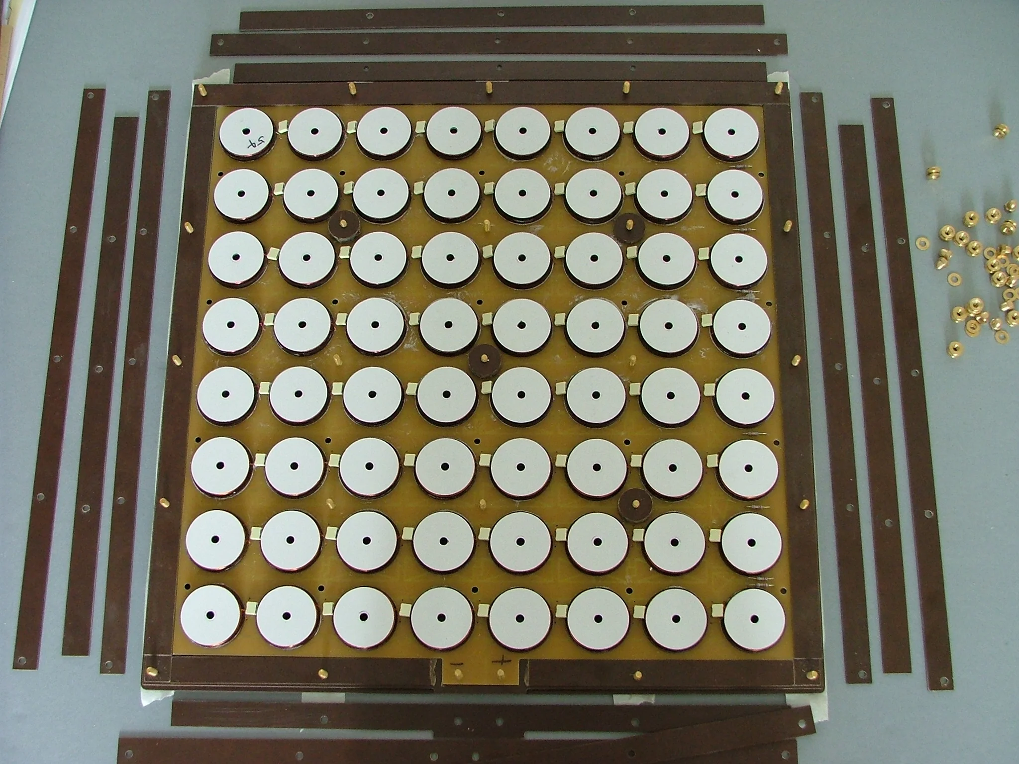 Air-core transformers are placed under each square of the chess board to power the tubes in a similar fashion to an induction charging system