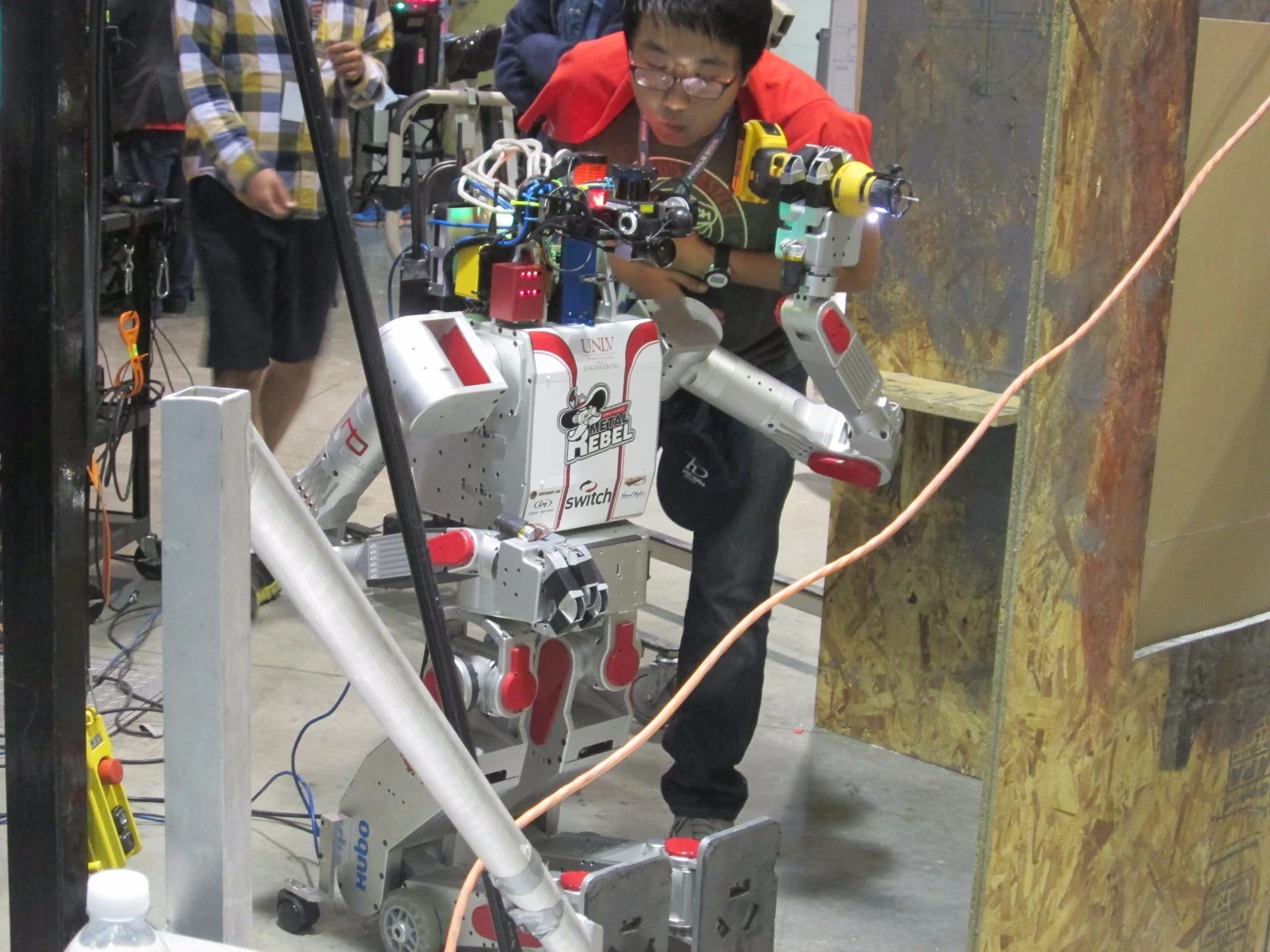 The robot DRC-Hubo (aka "Metal Rebel") receives some TLC at the DARPA Robotics Challenge