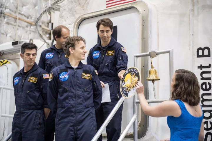 As they leave the module, the HERA XIII crew is given their mission patch to place on the door