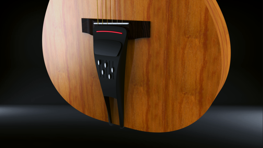 The Pulse attaches the an acoustic guitar's bridge pins and the strap peg