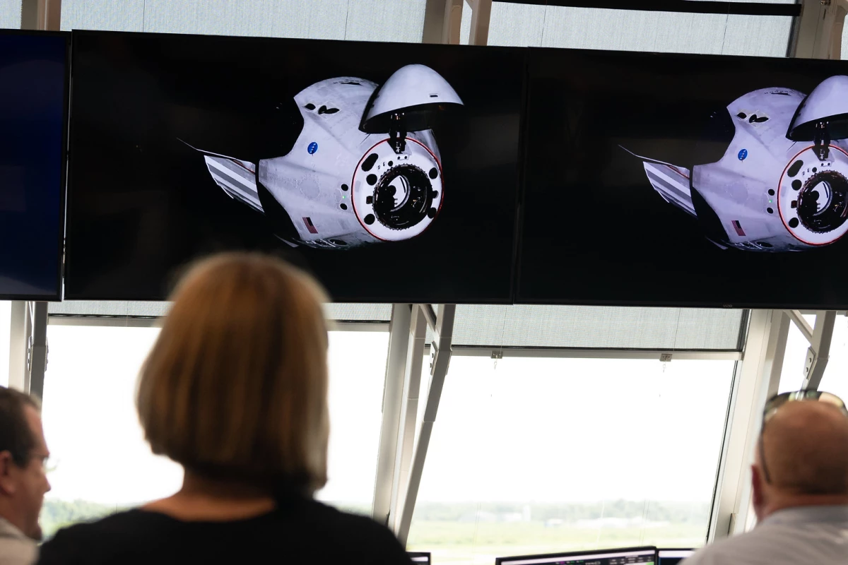 Mission control watches on as the Crew Dragon prepares to dock with the ISS