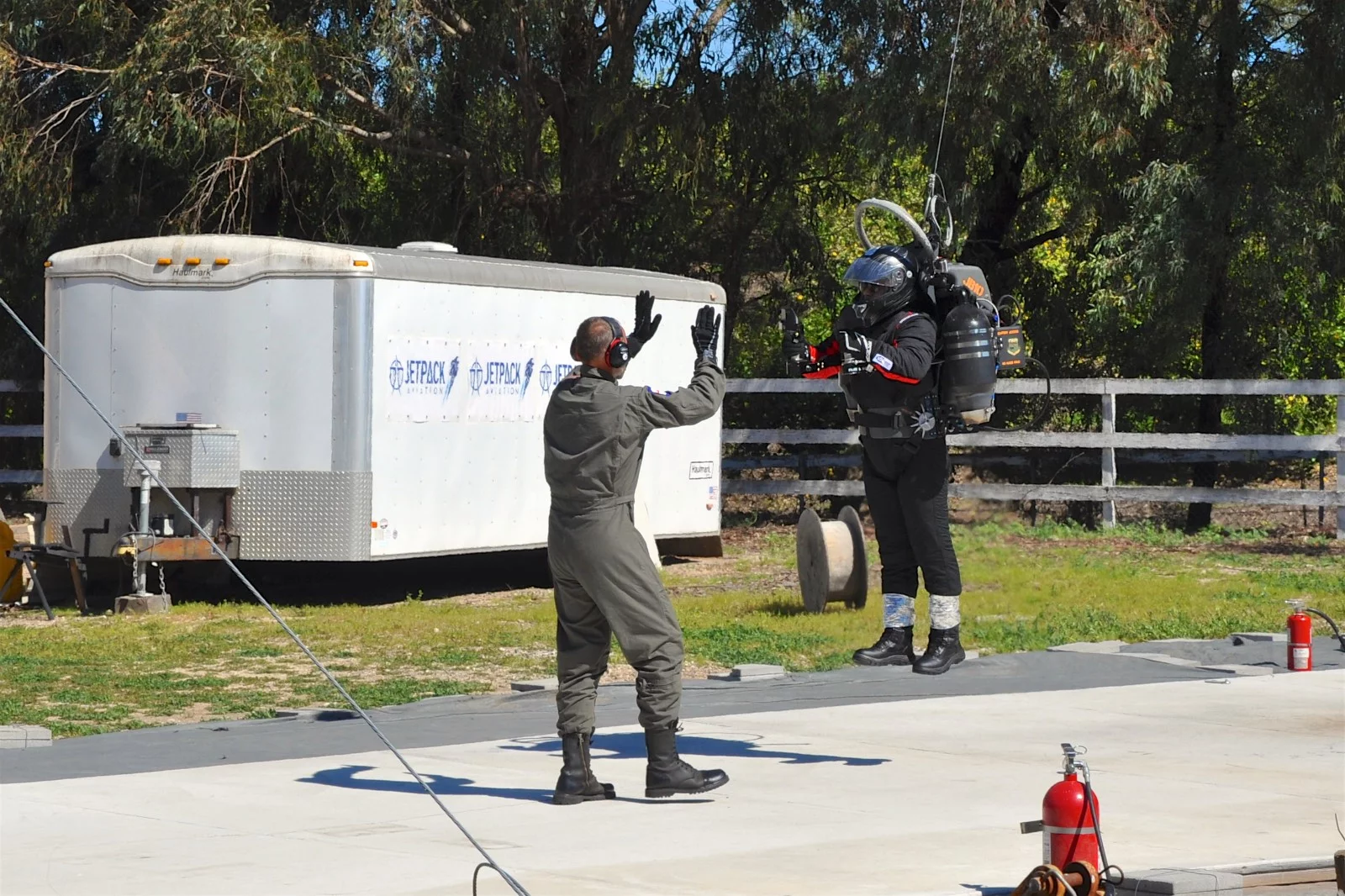Jetpack Aviation CEO David Mayman guides the first "civilian" Jetpack pilot through liftoff