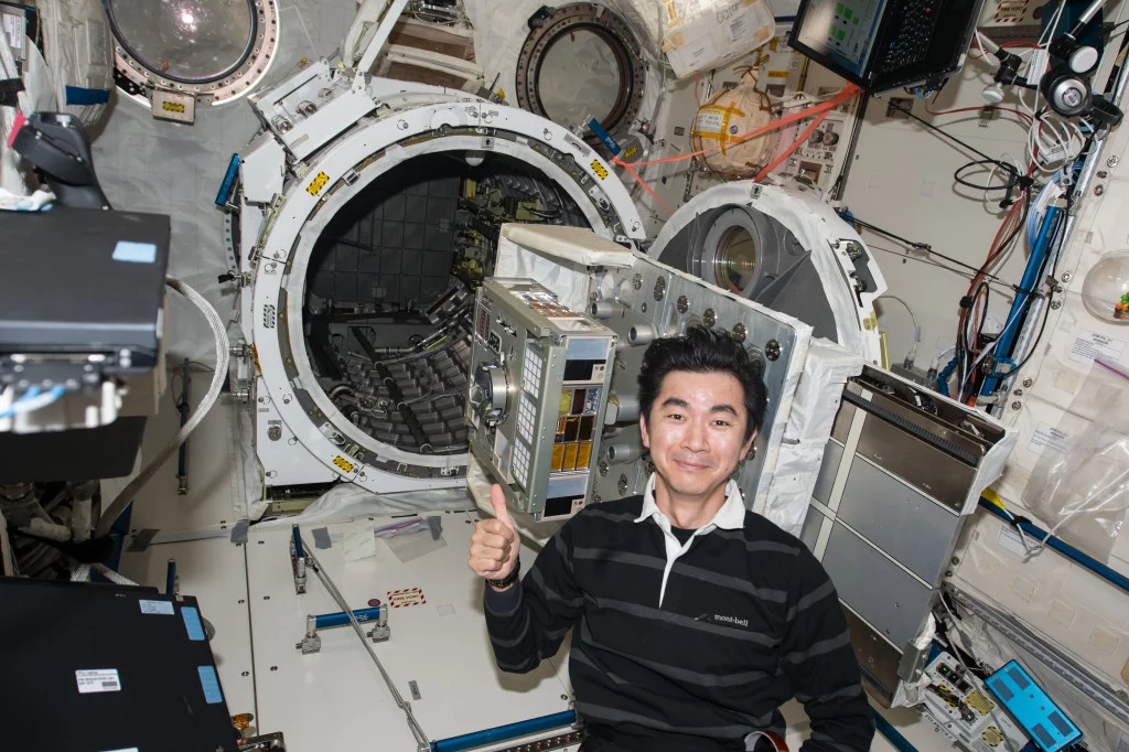 A Japanese astronaut sets up the experiment onboard the International Space Station