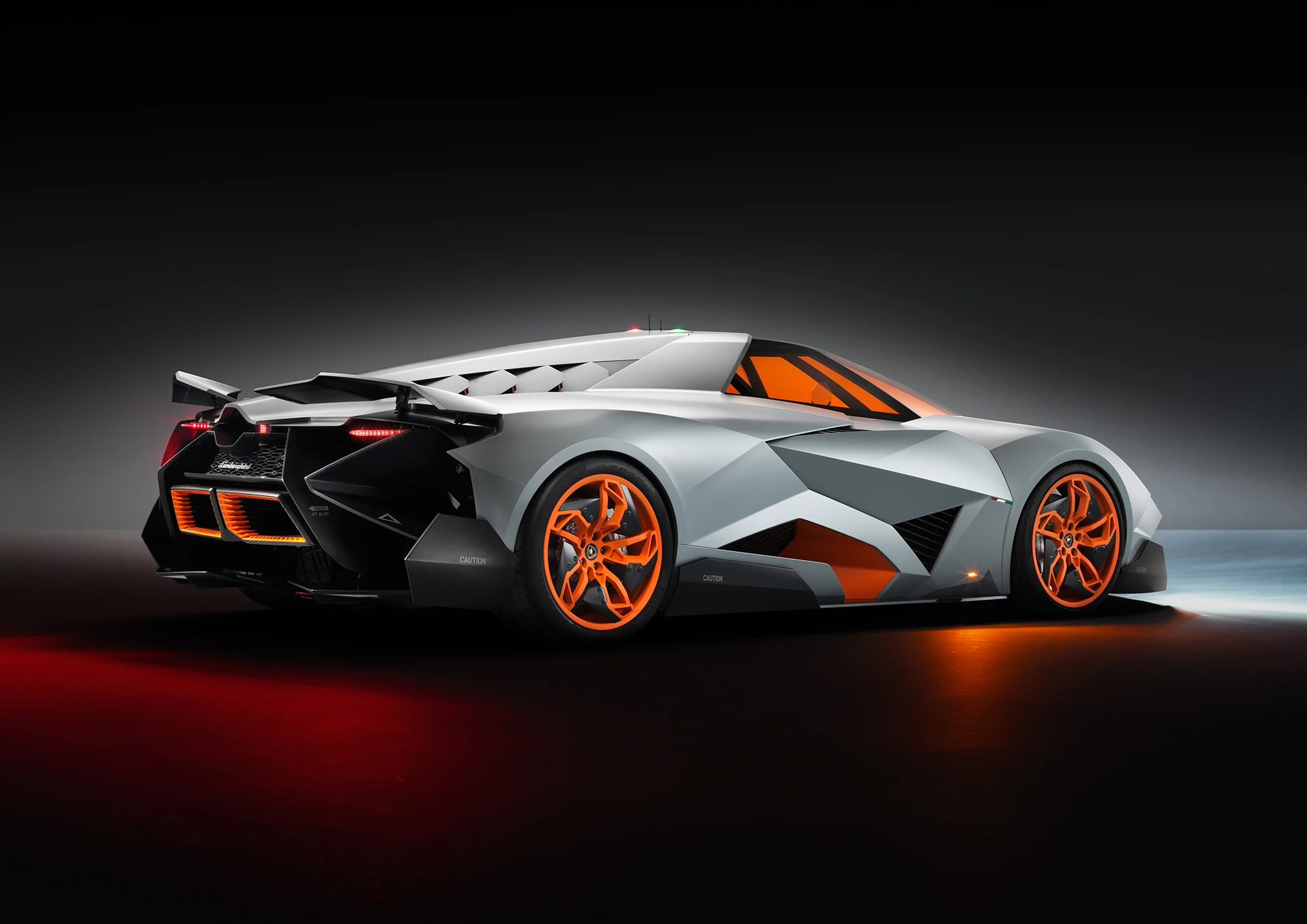 Two independent flaps located rearward activate automatically at high speeds for downforce while a series of intakes assist with engine cooling