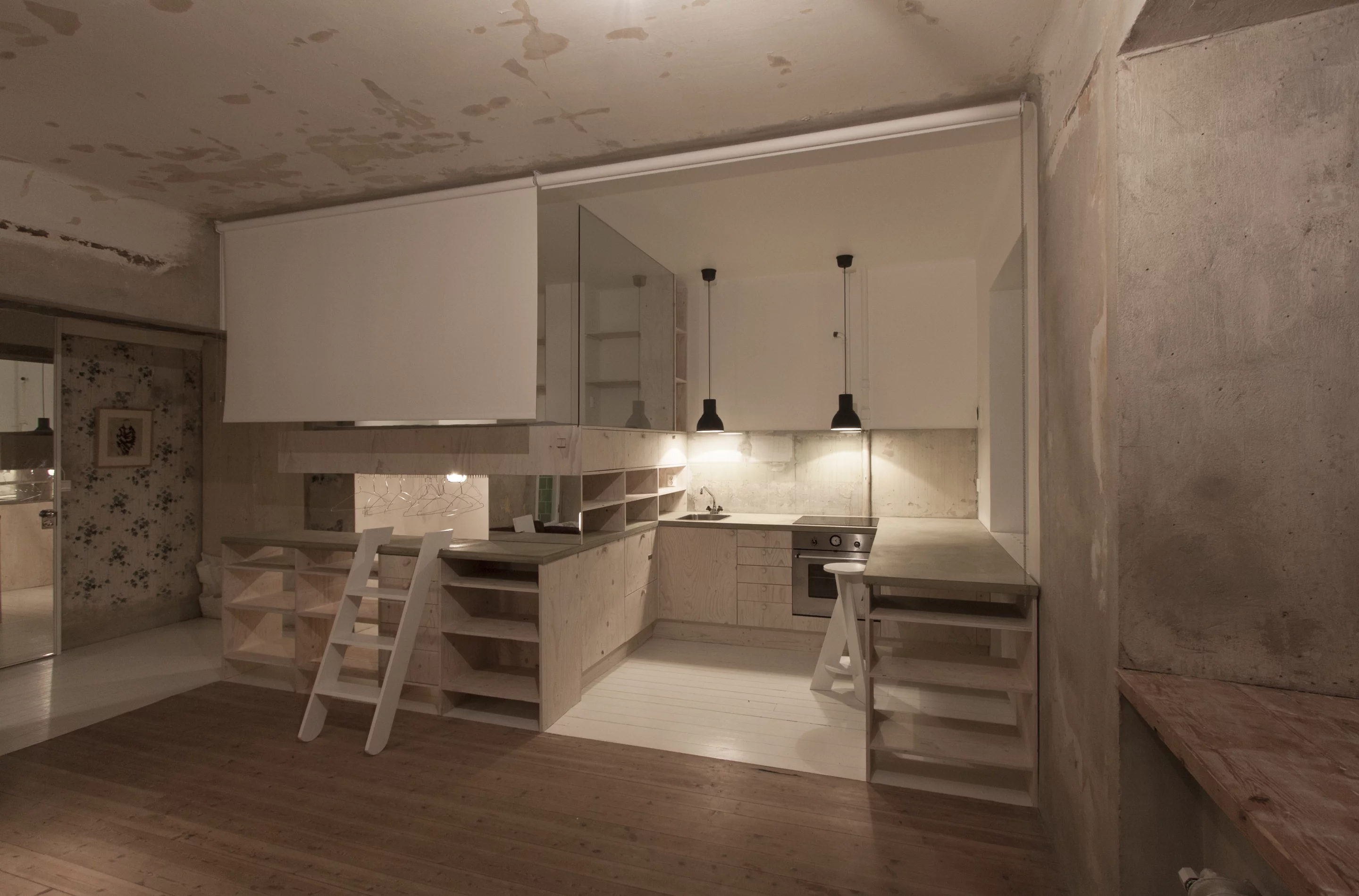 Glass panels are used to separate the kitchen/bed/wardrobe spaces from each other