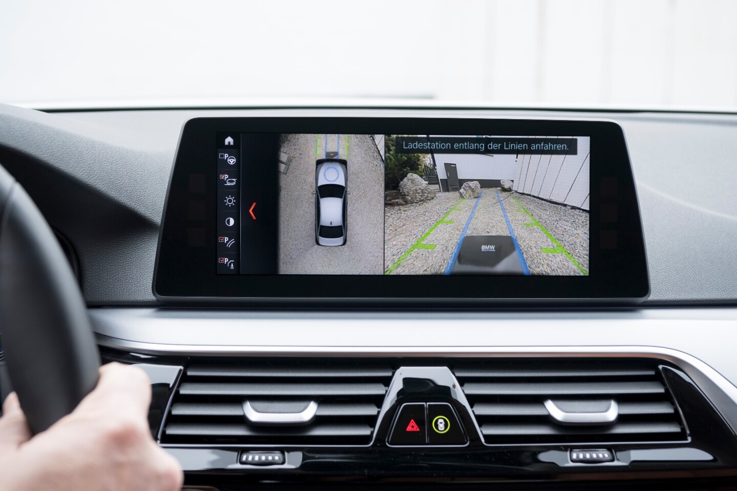 An overhead view of the vehicle guides the driver into position over the charging pad to gain optimum charging