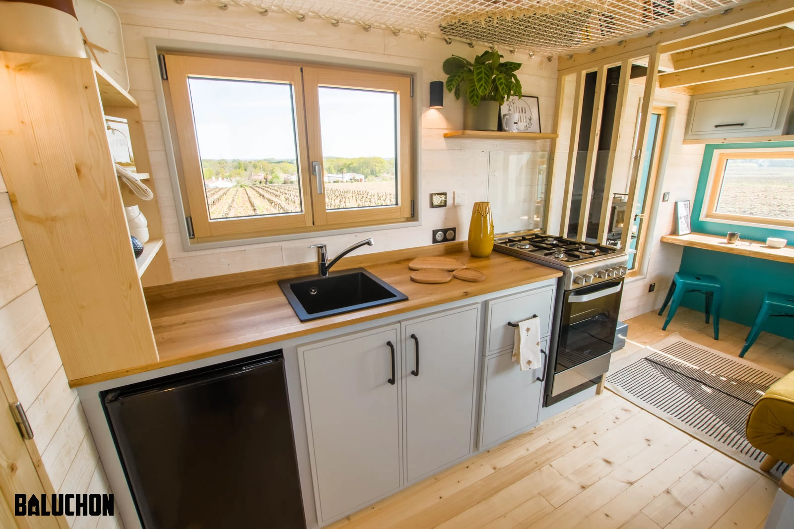 Tiny house Sïana's kitchen is basic and includes an oven with four-burner propane-powered stove