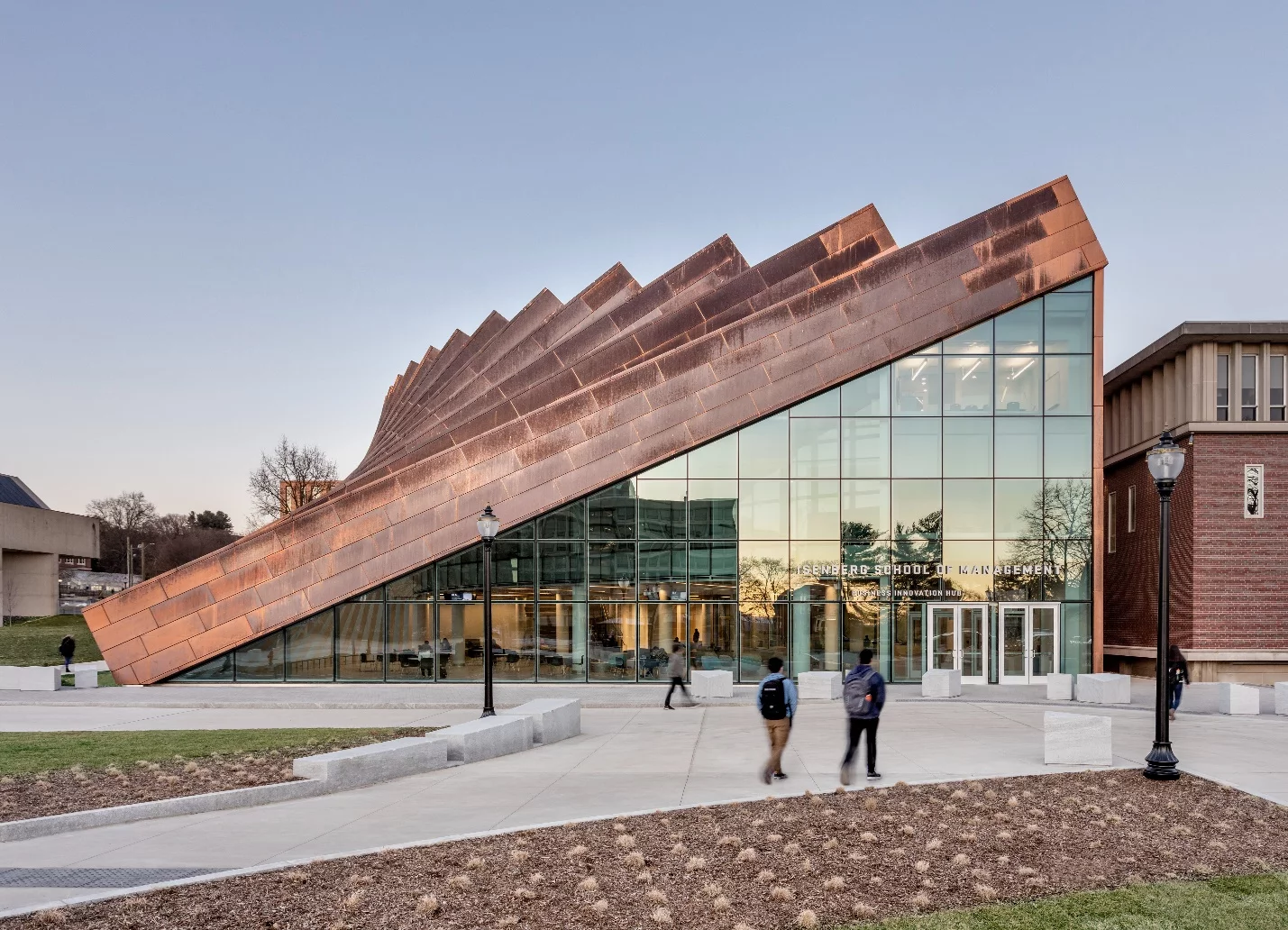 The Business Innovation Hub's exterior features vertical copper pillars, which gradually slope downward, forming a large triangular entrance