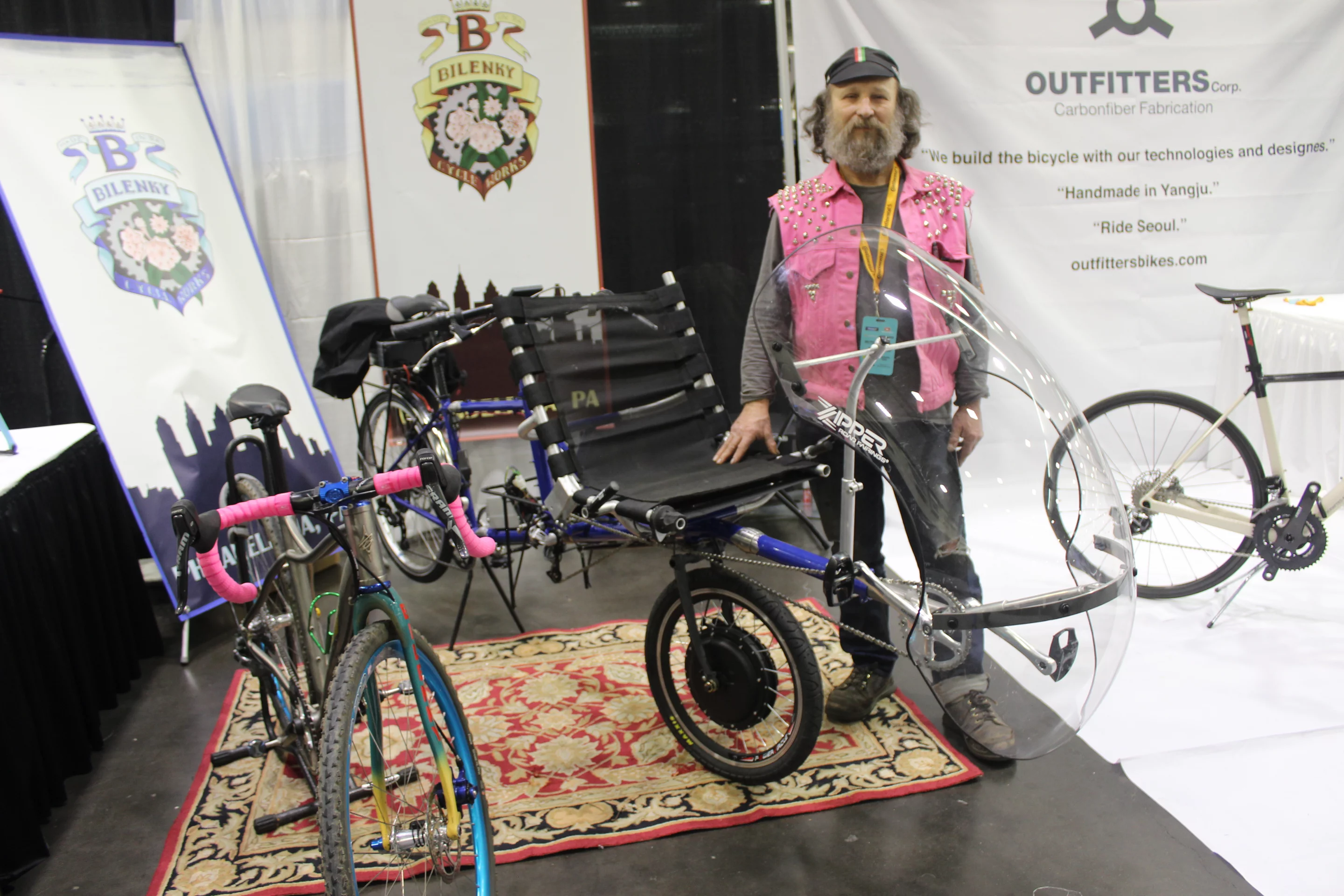 Stephen Bilenky stands with the latest version of his ViewPoint semi-recumbent bike, named the eHarmony