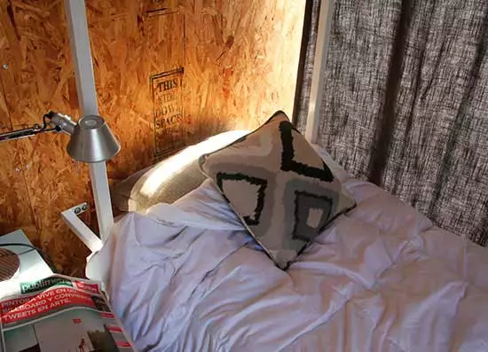 Most of the furniture is on wheels so they can be easily rearranged, and the bed folds up flat against the wall when needed