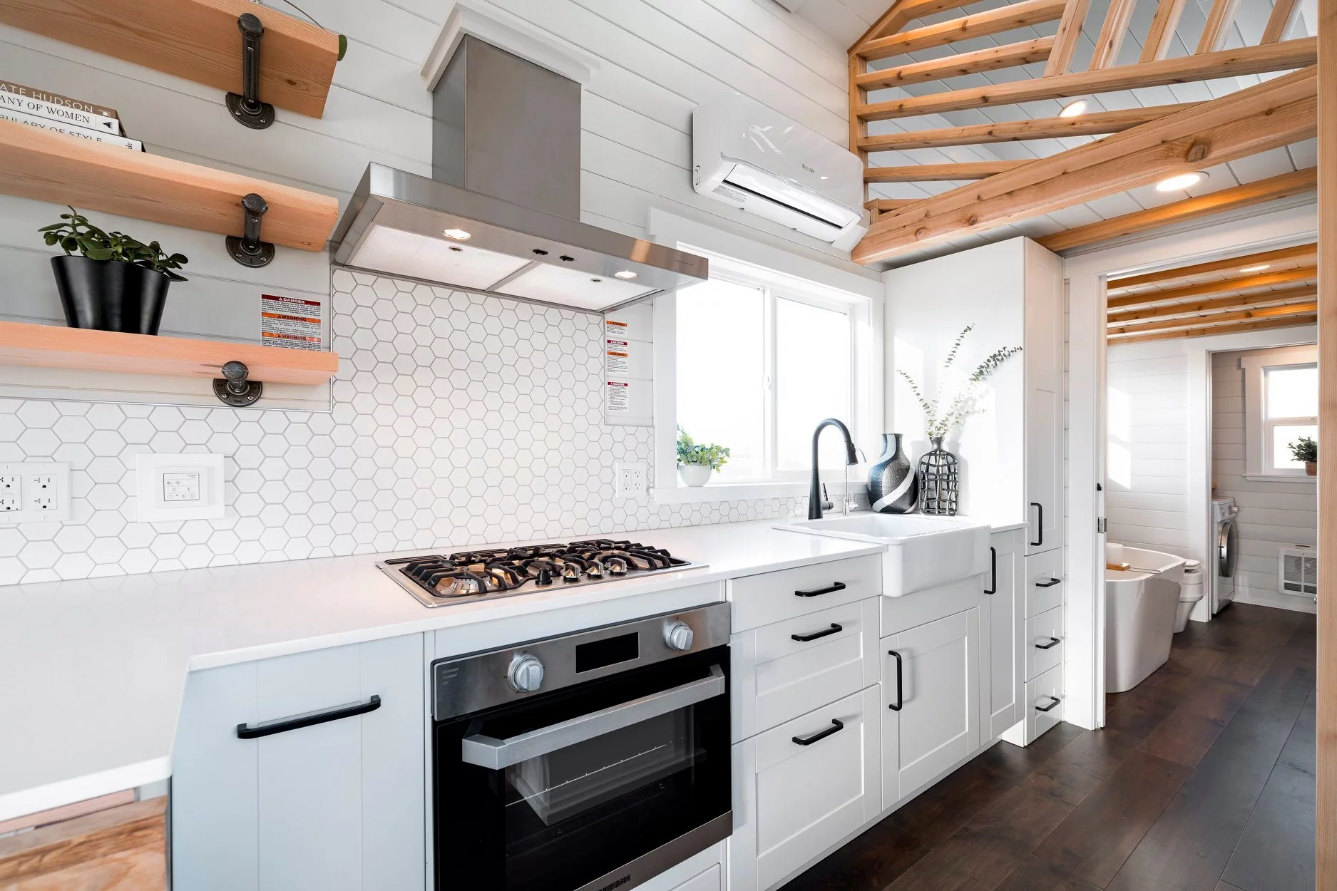 The 34ft Eco-Friendly Tiny House RV's floor is decked out in hardwood