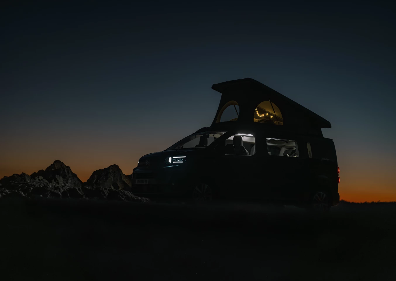 With a sliding convertible lower bench/bed and a sleeper roof, the Holidays camper is an efficient two-story camper