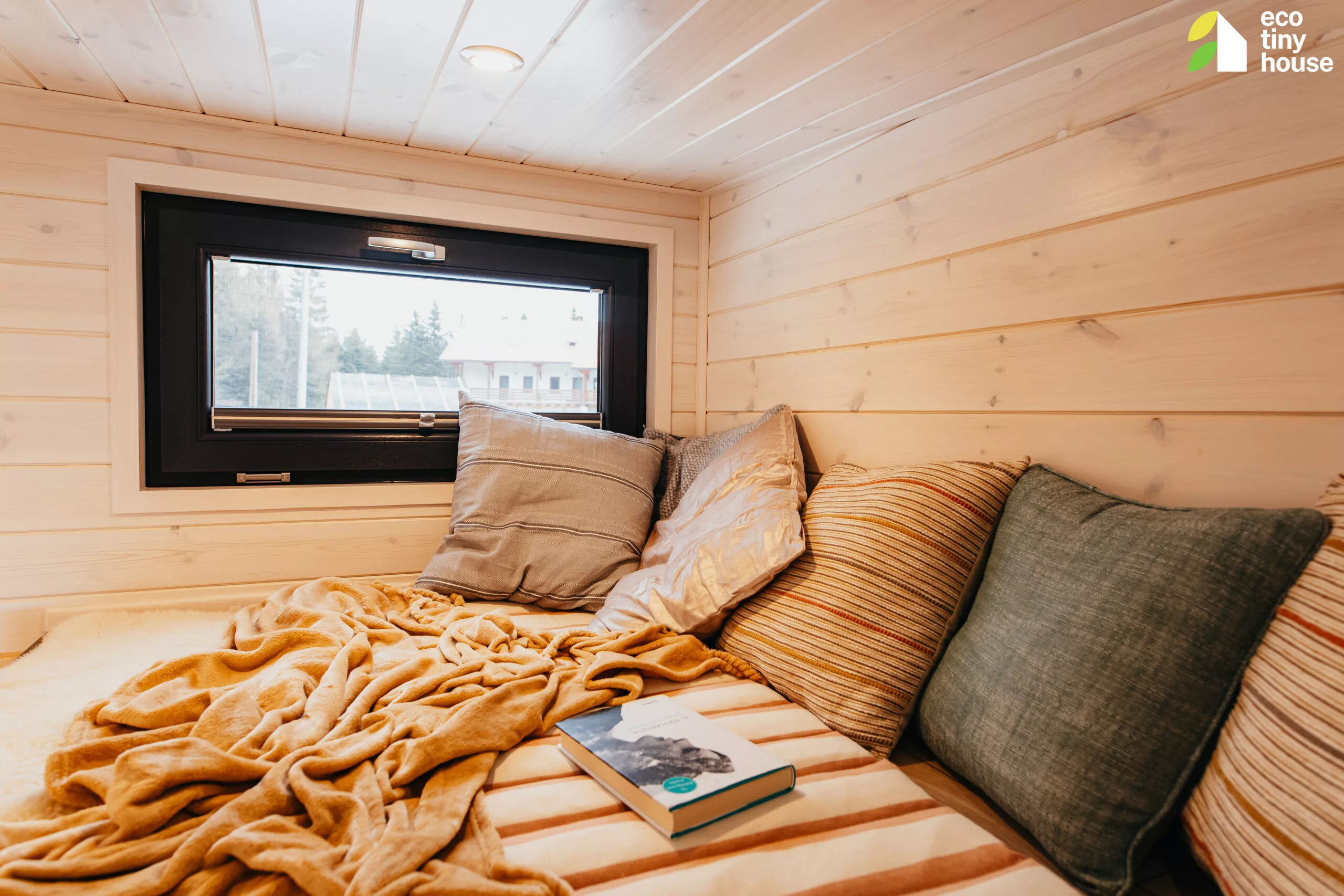 The Tiny Rubik's loft is reached by a wooden ladder and has a low ceiling and space for a bed