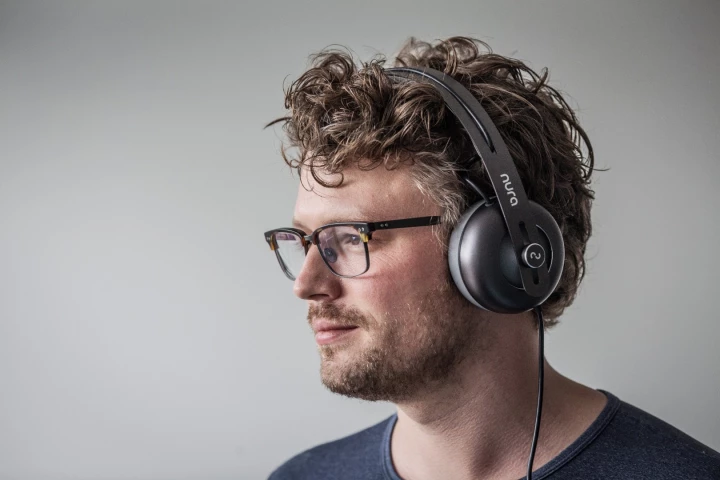Nura co-founder Kyle Slater with his revolutionary headphones, which measure the sensitivity of your ears across a range of frequencies and give every listener a unique EQ profile for each ear
