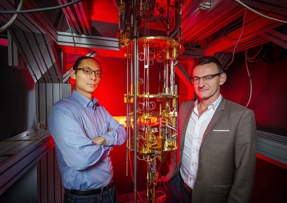 Dr Henry Yang and Professor Andrew Dzurak of UNSW, with the kind of large, expensive dilution refrigerator currently used to supercool quantum computing qubits. Their new hot qubit technology could remove the need for such bulky, expensive cooling systems