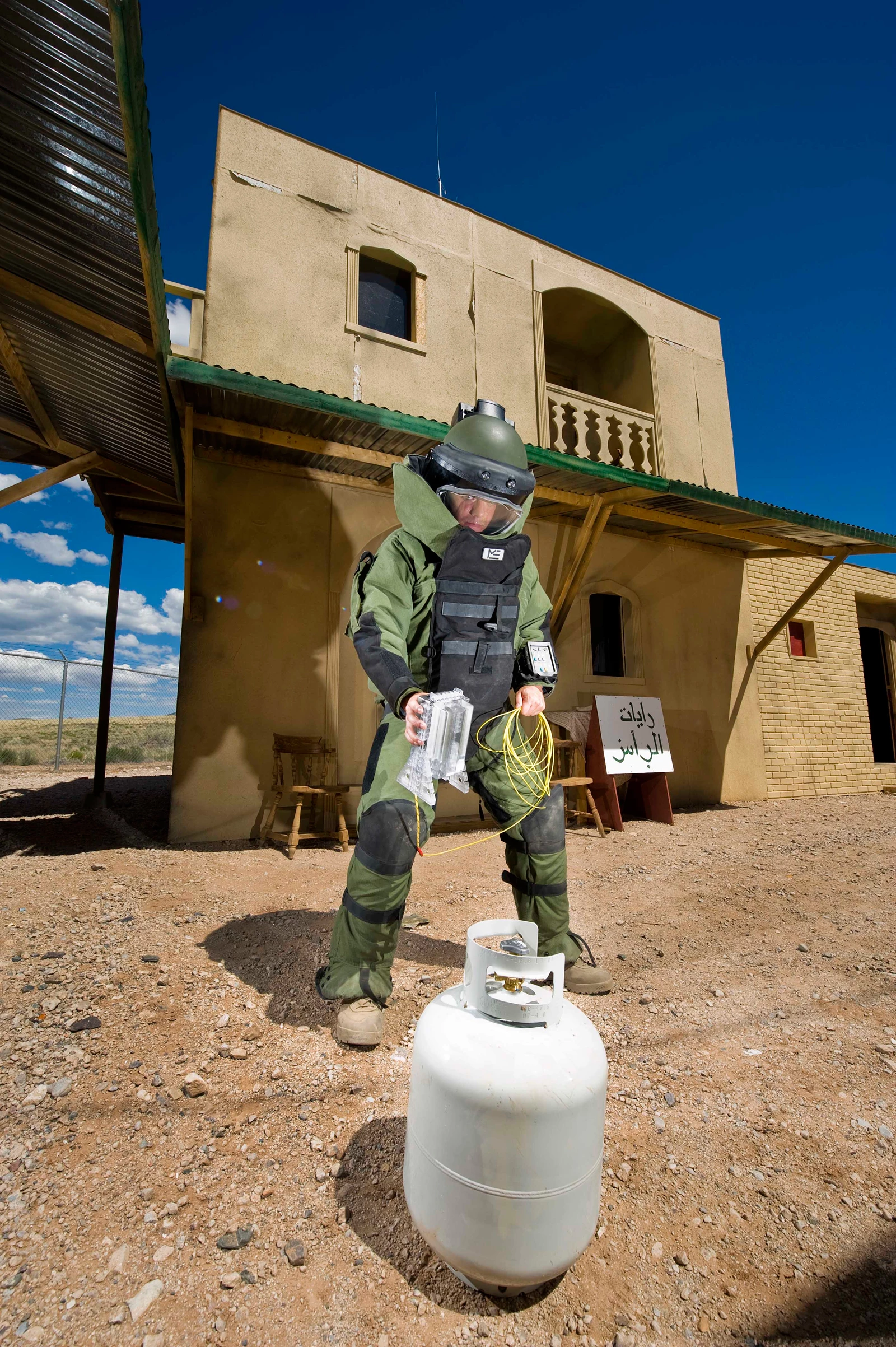 Airman 1st Class Patrick Connolly of Dayton, Ohio, demonstrates the placement of the water disruptor in a simulated village used to train soldiers heading overseas (Image: by Randy Montoya)