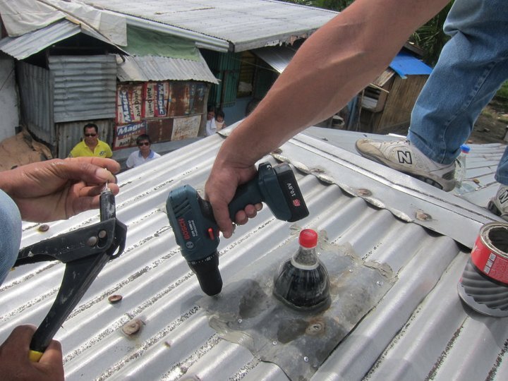A Solar Bottle Bulb being installed (Photo: Isang Litrong Liwanag)
