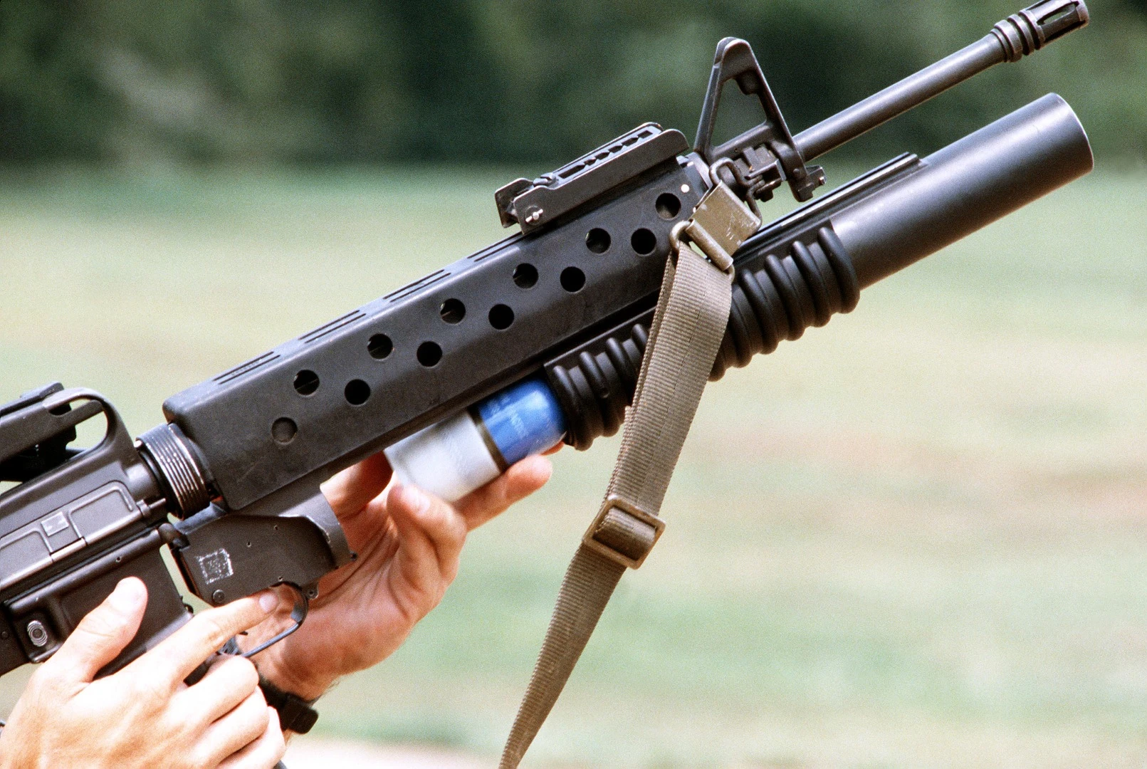 A 40-mm practice grenade, similar in appearance to the anti-drone grenade, is loaded into a portable launcher