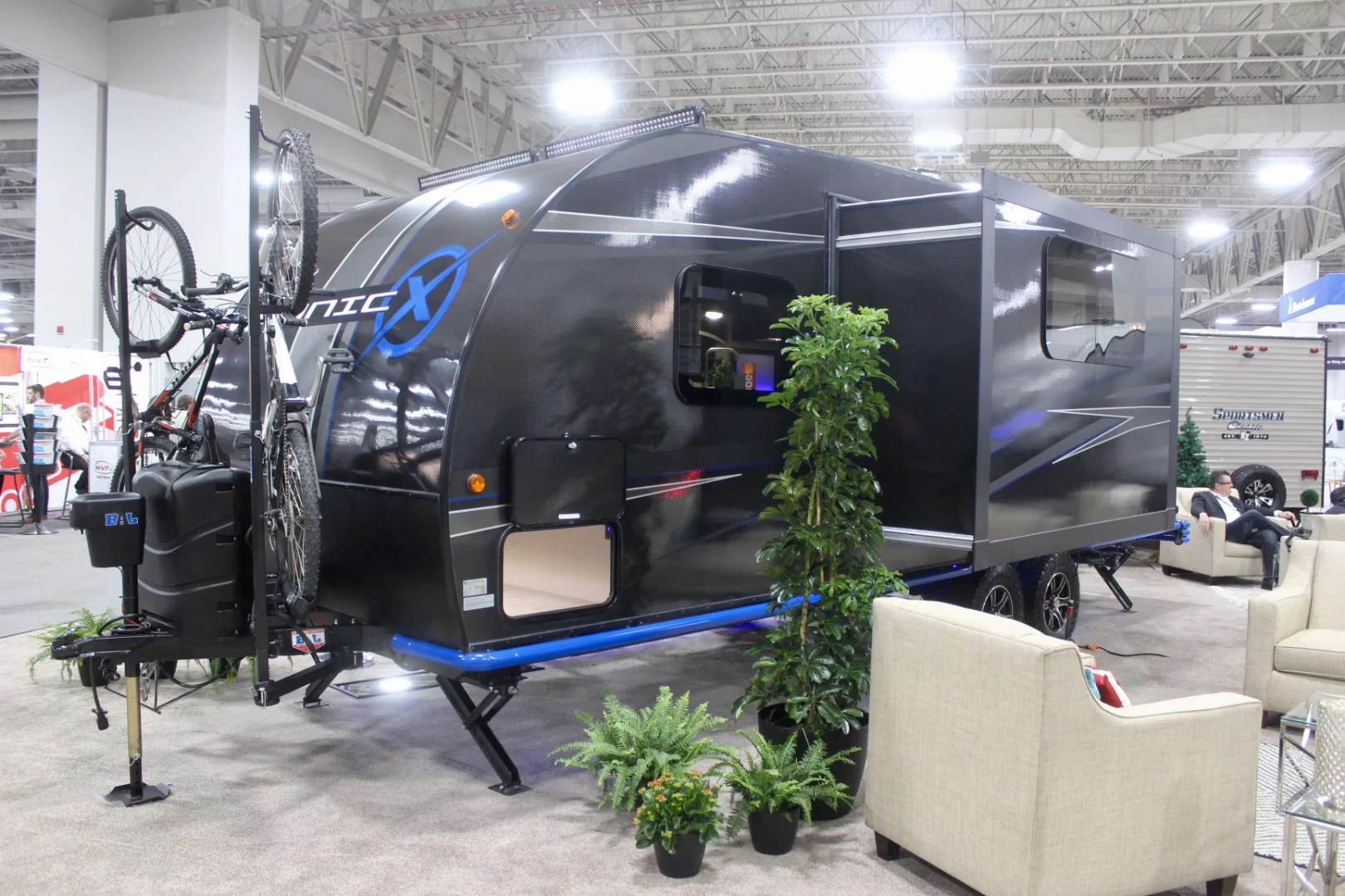 The Sonic X's slide-out increases interior space, providing room for a comfy dining lounge with wraparound sofa