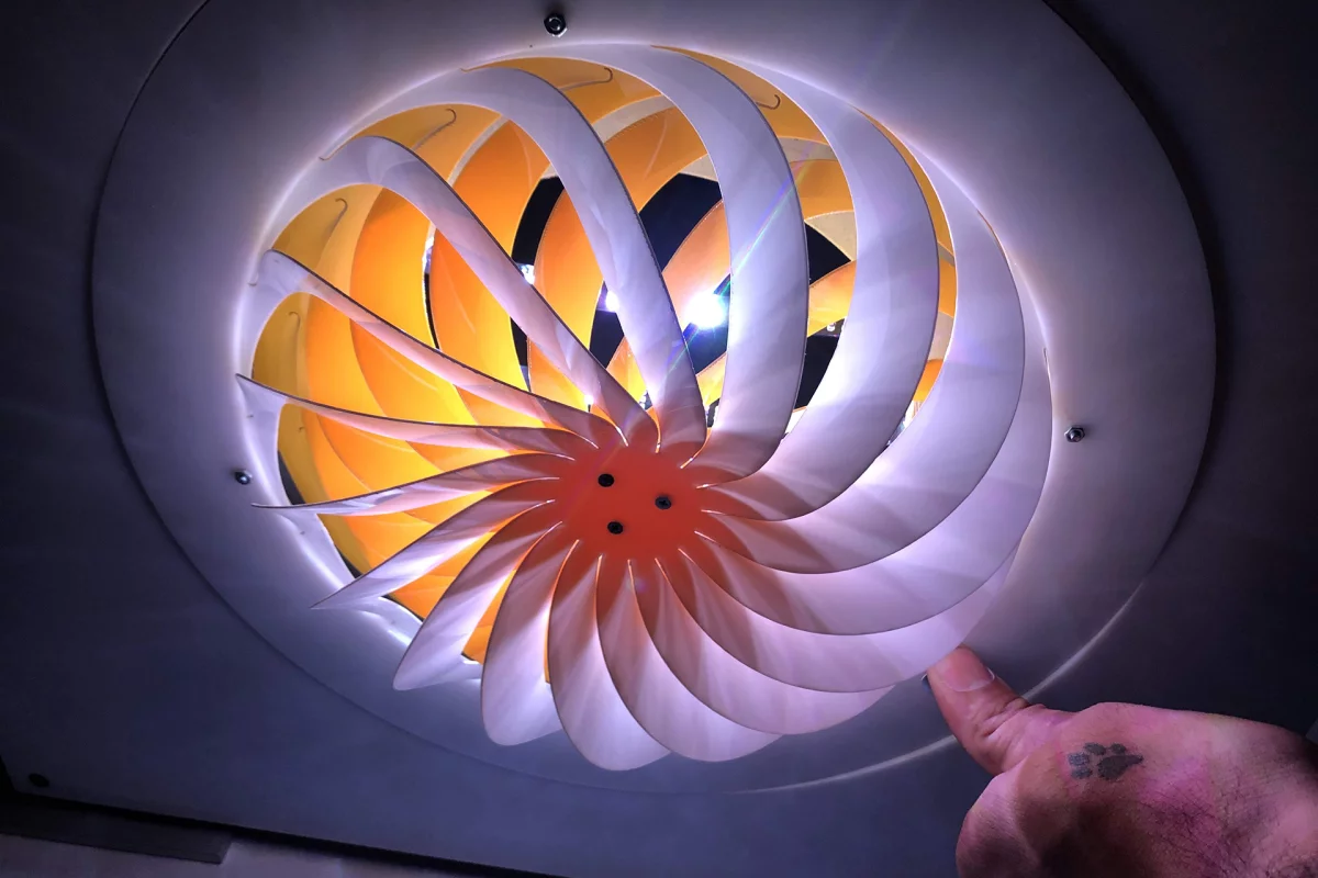 The slats of this Kiriform lamp shade can opened or closed to let out more or less light, by rotating the perimeter of the device