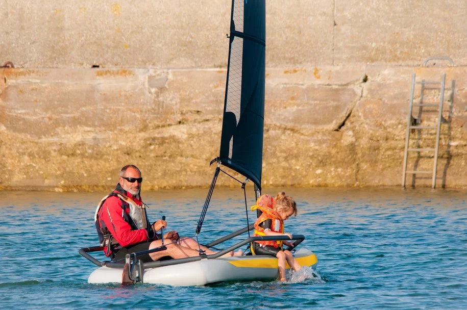 A man and child enjoy a pleasant day's sailing (Photo: Tiwal)