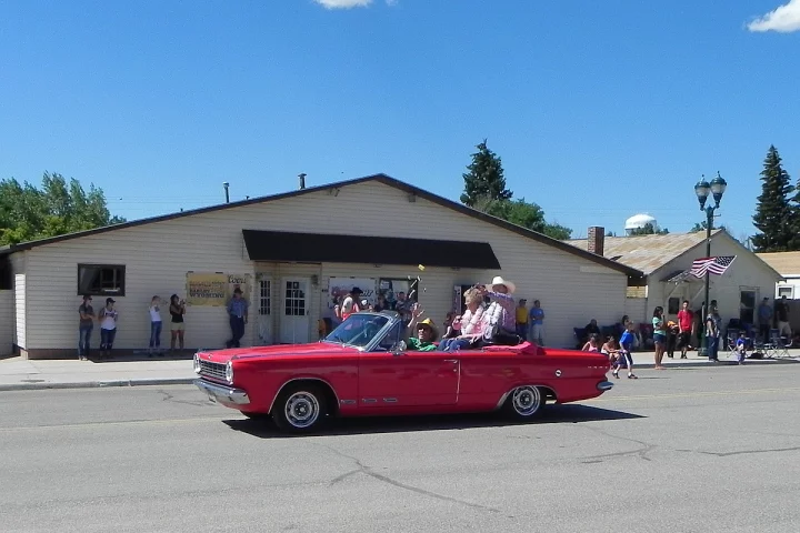Escorting the grand marshals of the parade held annually by the little town of Albin, Wyoming, the 1965 Dodge Dart GT Convertible with newly-installed RimBlades