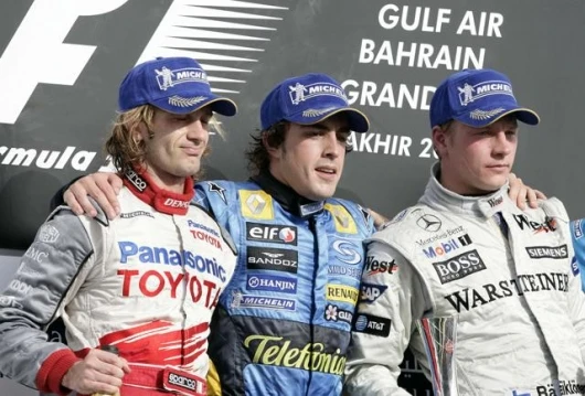 Toyota's Jarno Trulli, Renault's Fernando Alonso and McLaren's Kimi Raikkonen on the victory dias