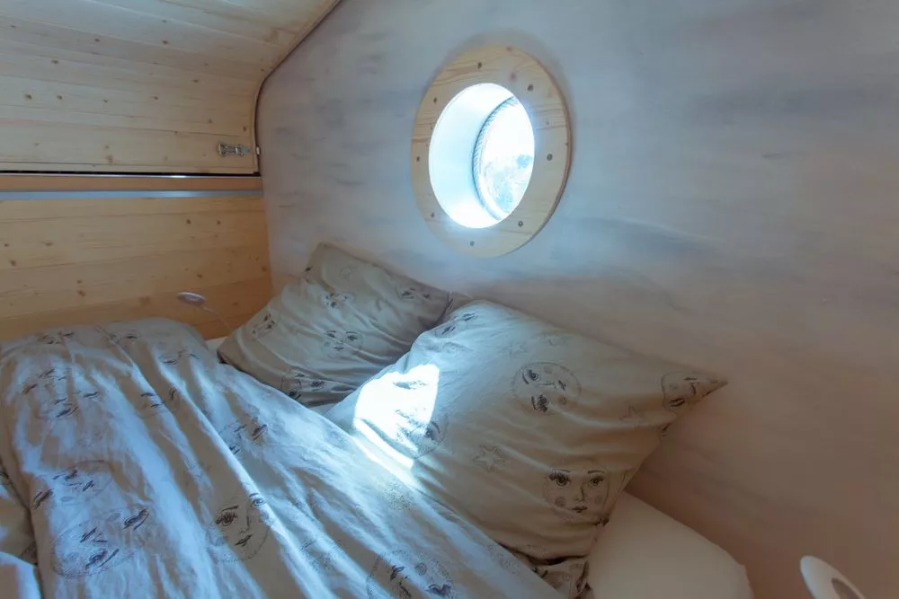 La Tête dans les étoiles' loft bedroom, shown with the roof in the closed position