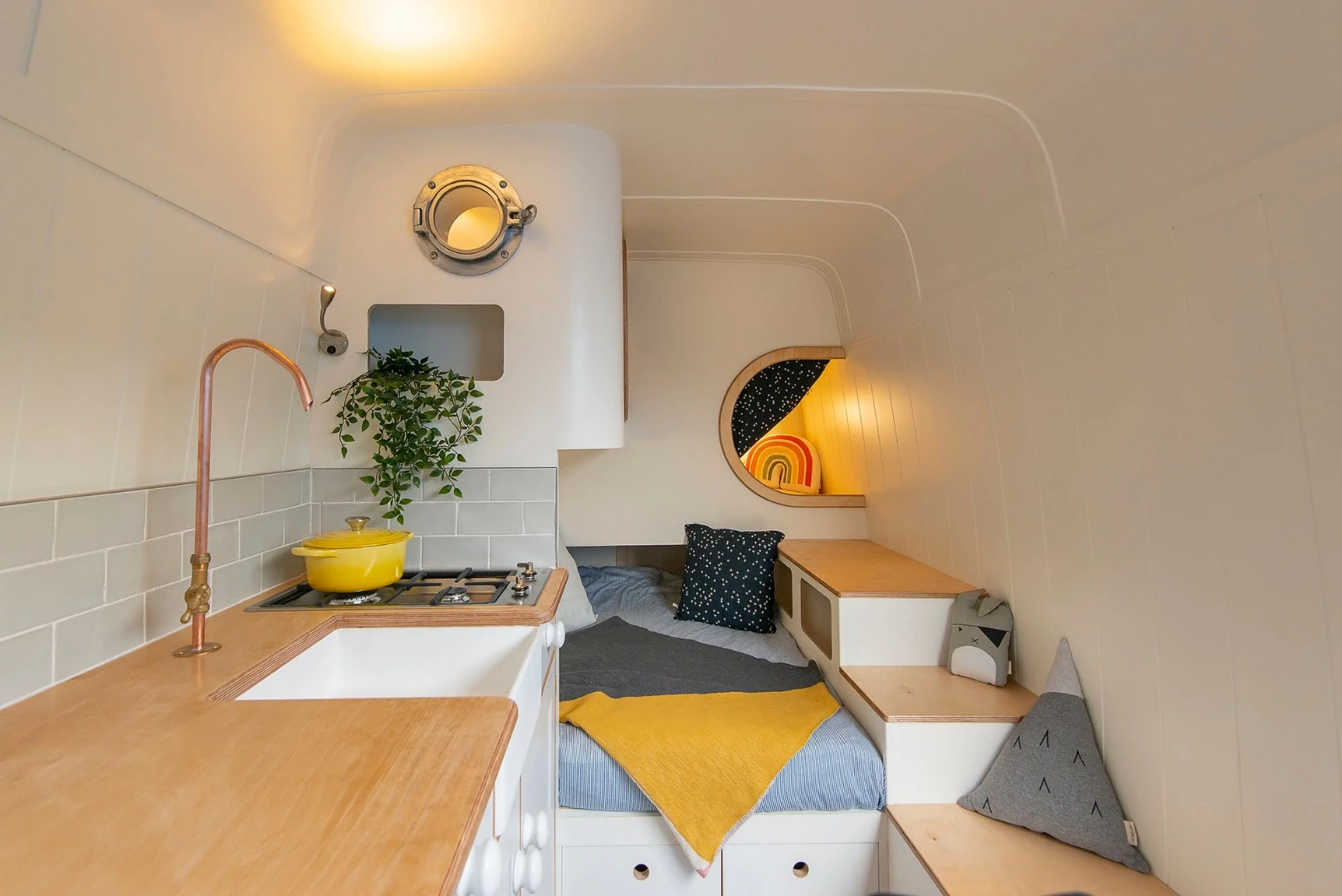 The added bonus of this specific conversions is its creative stacked pod beds, allowing the mobile home to sleep up to four adults comfortably