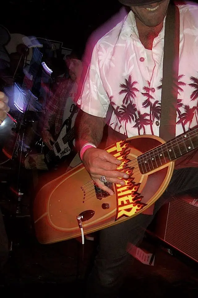 Pro skateboarder Gianfranco de Gennaro Gilmour shredding on a longboard Skate Guitar