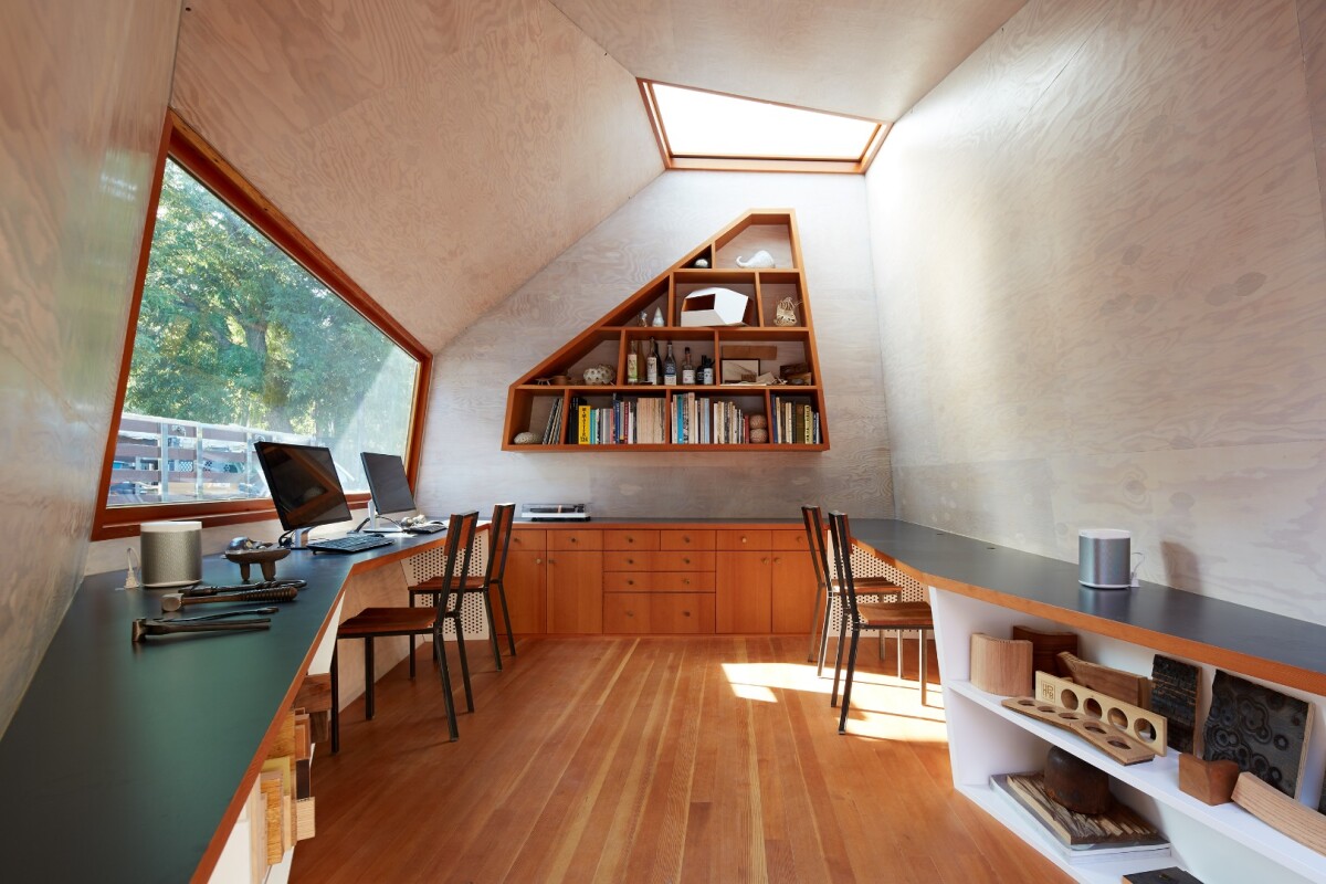 Inside, the office features beautiful wooden interior wall paneling and flooring, four computer work stations, and plenty of storage