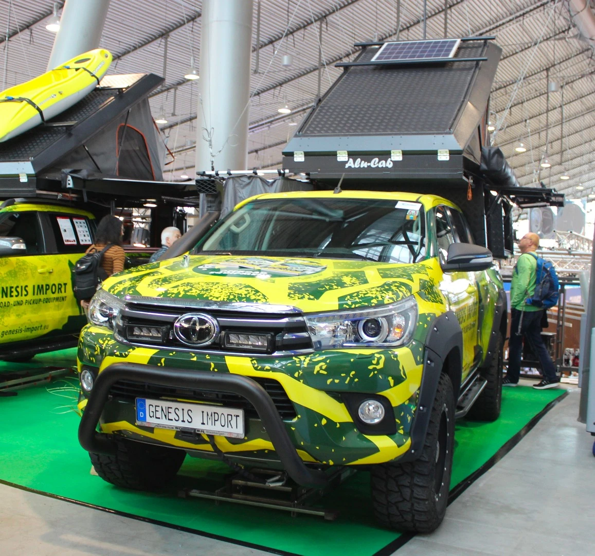 Genesis Import shows a Toyota expedition pickup with Alu-Cab pop-top camper