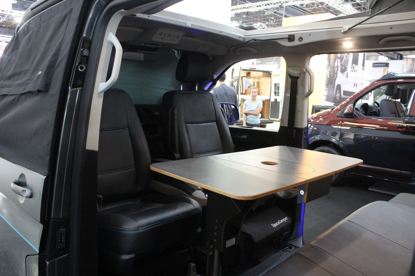 Swivel seats and a collapsible table inside the SpaceCamper LightOpen - the table is designed to hold a tabletop cooker for a different type of camp cooking