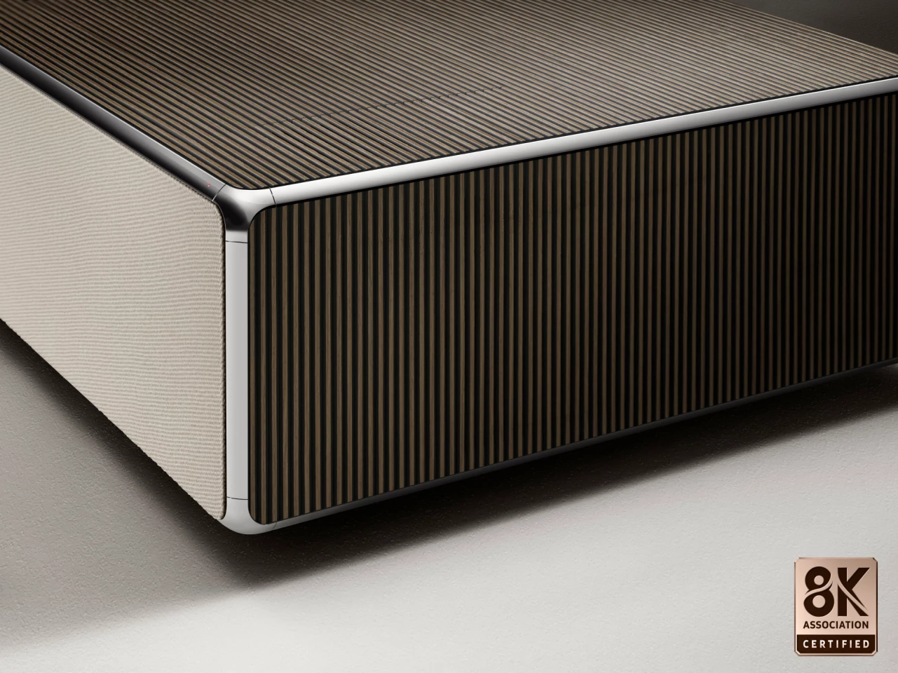 A light fabric speaker grille hides a 100-W Atmos sound system, plus clever technology that tweaks the output so it appears to be coming from the screen