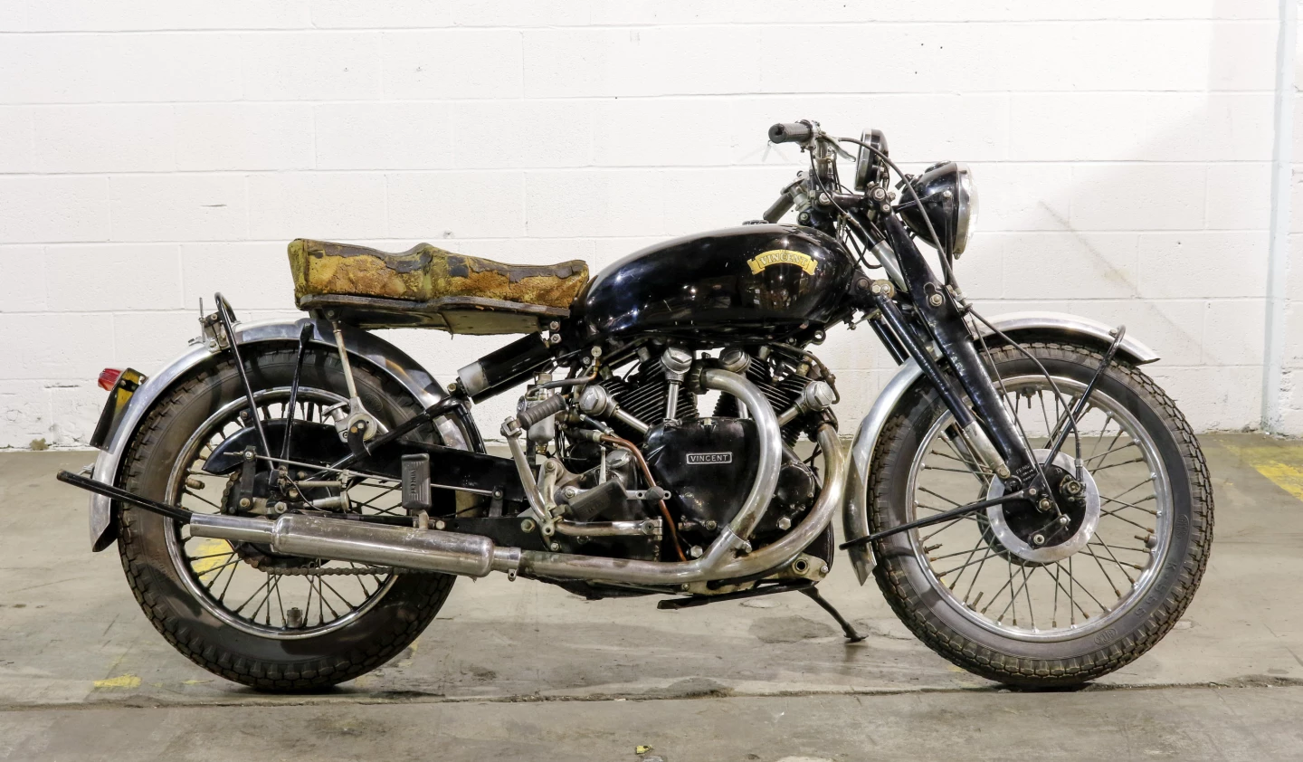 Another great story behind this bike, which was first purchased in 1950 from Atlantic Motorcycles in Boston by one Louis Kazajian. Kazajian was an avid motorcyclist, sportsman and storied adventurer. In the early 1950s, he singlehandedly drove from Watertown up the ALCAN Highway. One month and twelve tires later he earned the moniker "Yukon Lou", which aptly described his zest for life. A "confirmed bachelor", when Kazajian was not fishing, hunting, motorcycling or doing other "manly man" activities, he was fighting fires for the Watertown Fire Department. He rode the Shadow until 1969 when he thought it wasn't running well and parked it in his basement. There it sat until spring 2012. In July, 2012, after simple recommissioning (massaging and coaxing of all mechanical systems, multiple fluid changes, adjusting valves and rebuilding the carburettors), the Vincent came back to life after four kicks. It sold at Bonhams' 2015 Vegas sale for $103,500.