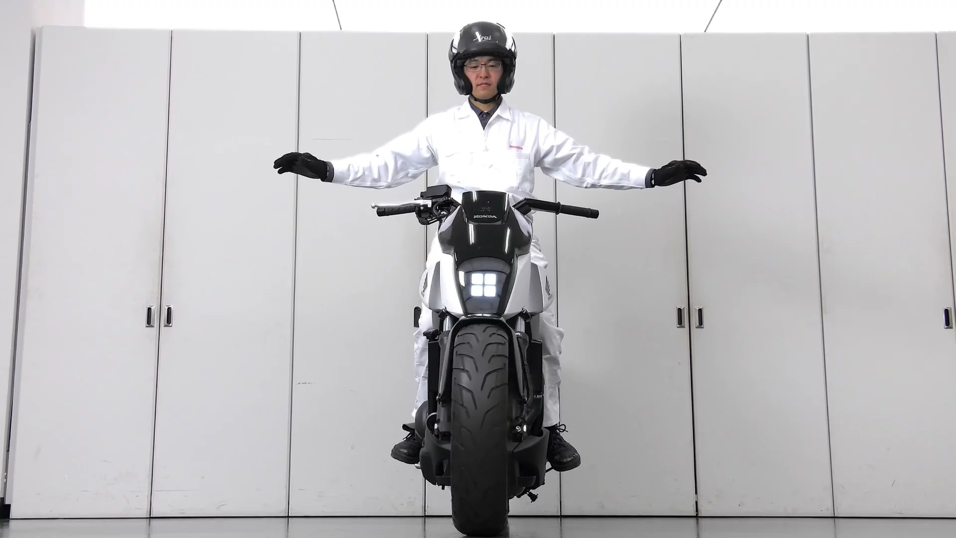 Honda's self-balancing motorcycle: I love to believe Honda R&D guys dress like this all day
