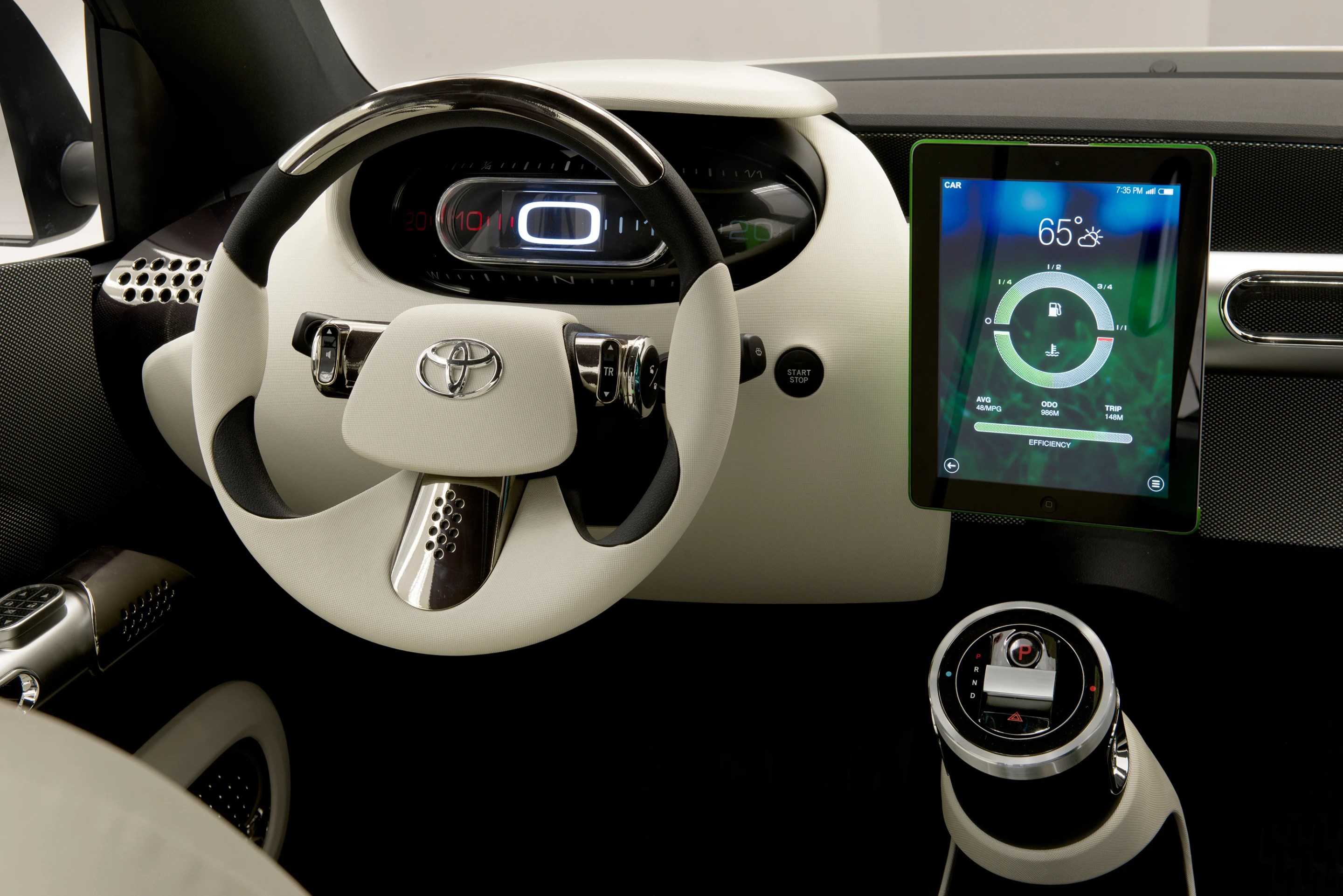 The driver’s area features a minimalist digital dashboard and a shifter design that looks like a containment tube from any number of sci-fi movies
