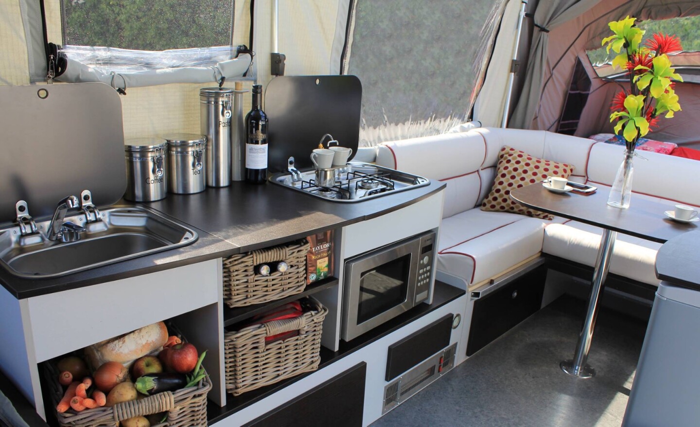 The Opus includes a well-equipped interior with two sleeping areas, a couch and a kitchen