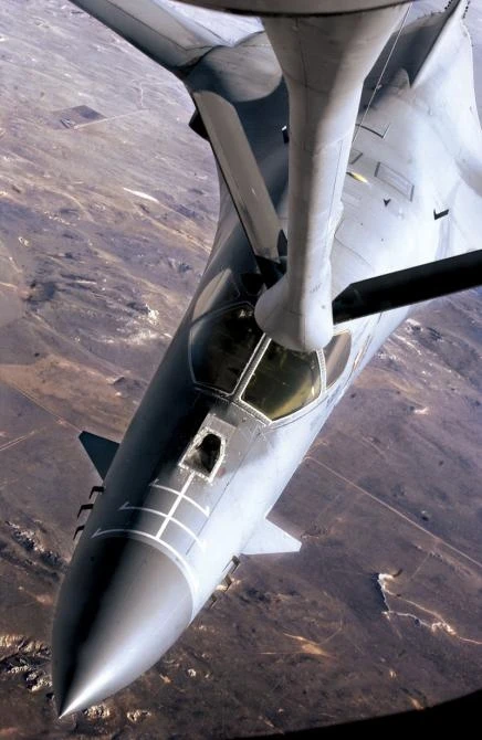 A B-1 Lancer negotiates its way to an aerial refueling boom of a KC-135 Stratotanker